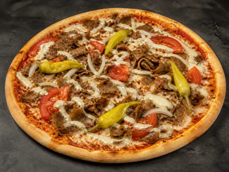Kebabpizza med kebabkött, lök, tomat, kebabsås och feferoni.